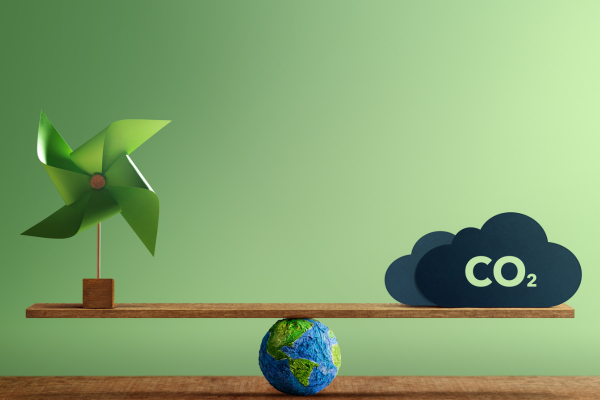 Balancing scale with CO2 and green energy symbols