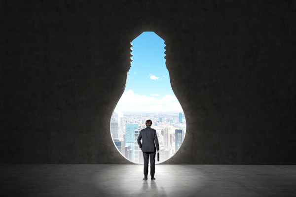 Person looking through an opening towards a green, innovative future